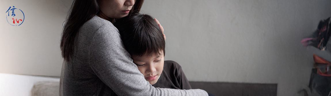 Mother hugging and comforting her child about grief.